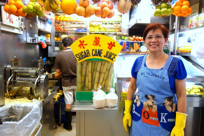 Hawker in Singapore selling fresh fruit juices including sugar cane, star fruit, coconuts, and more | Shopkeeper Stories