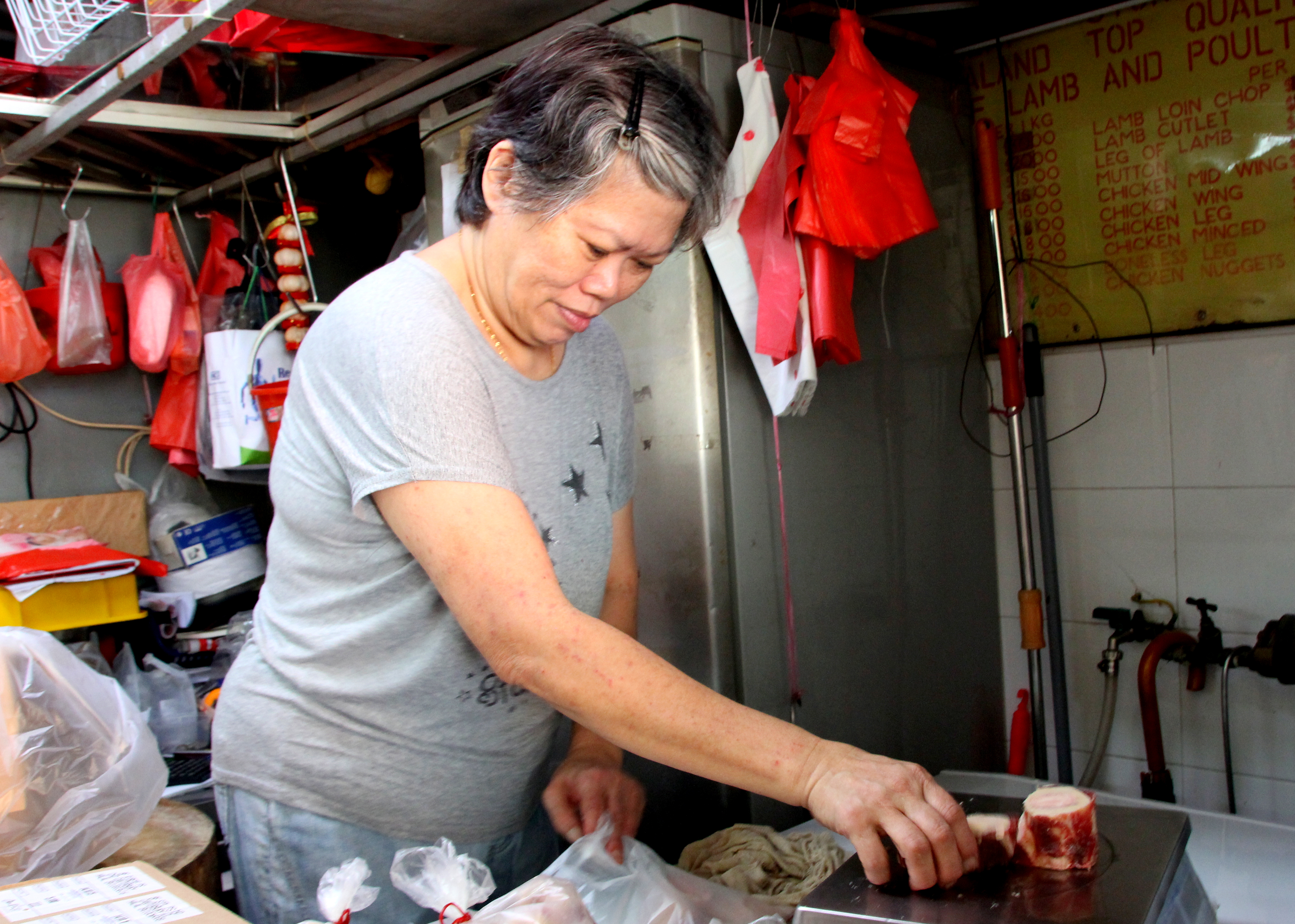 Butcher of frozen meat at a wet market in Toa Payoh, Singapore | Shopkeeper Stories